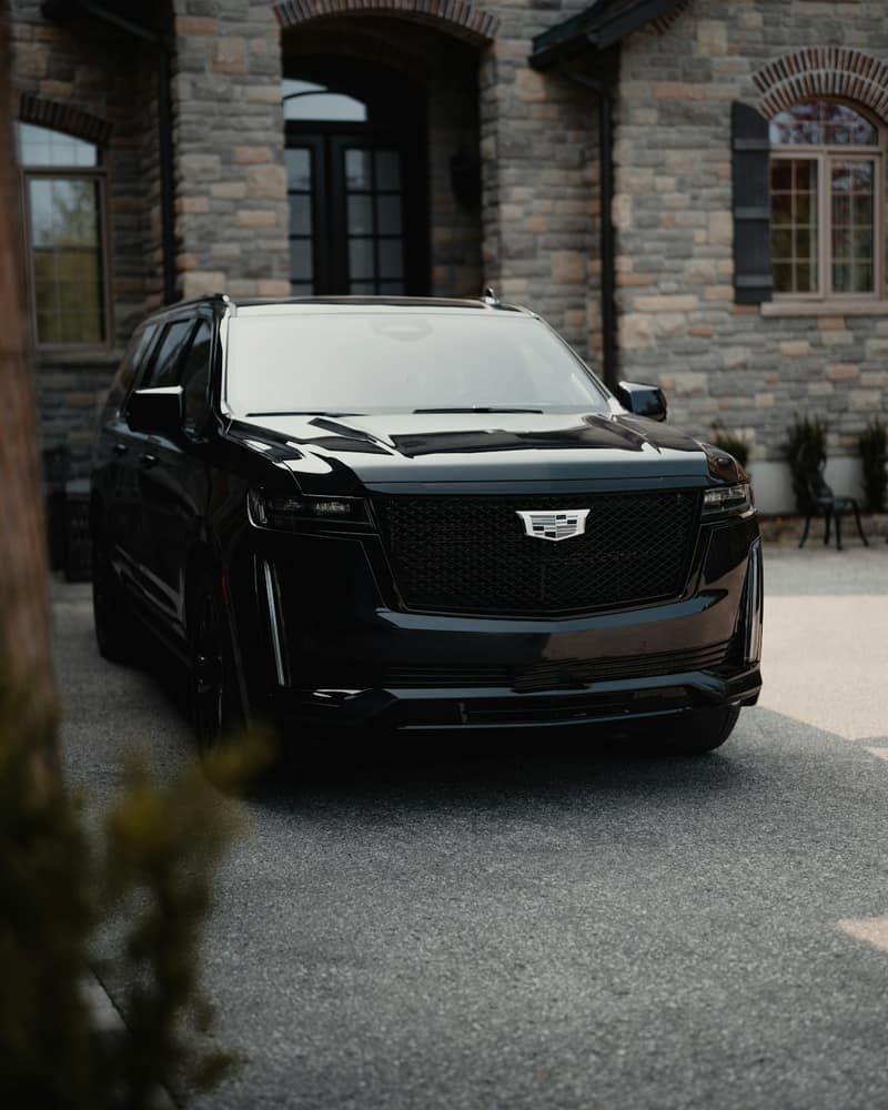 Black Cadillac Escalade front view at a private residence